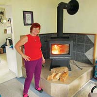 Woman standing in front of a wood stove